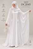 A woman modeling a white abaya with a matching hijab, shown against a plain beige studio background. The abaya has long flowing sleeves with pearl-like trim and tassels, and the model is holding a matching pearl-trimmed handbag.